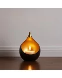 Teelicht & Goldlicht - Teelichschale Bola bronze-gold 15 cm - auf Boden vor weisser Wand mit Leiste im halbdunkeln